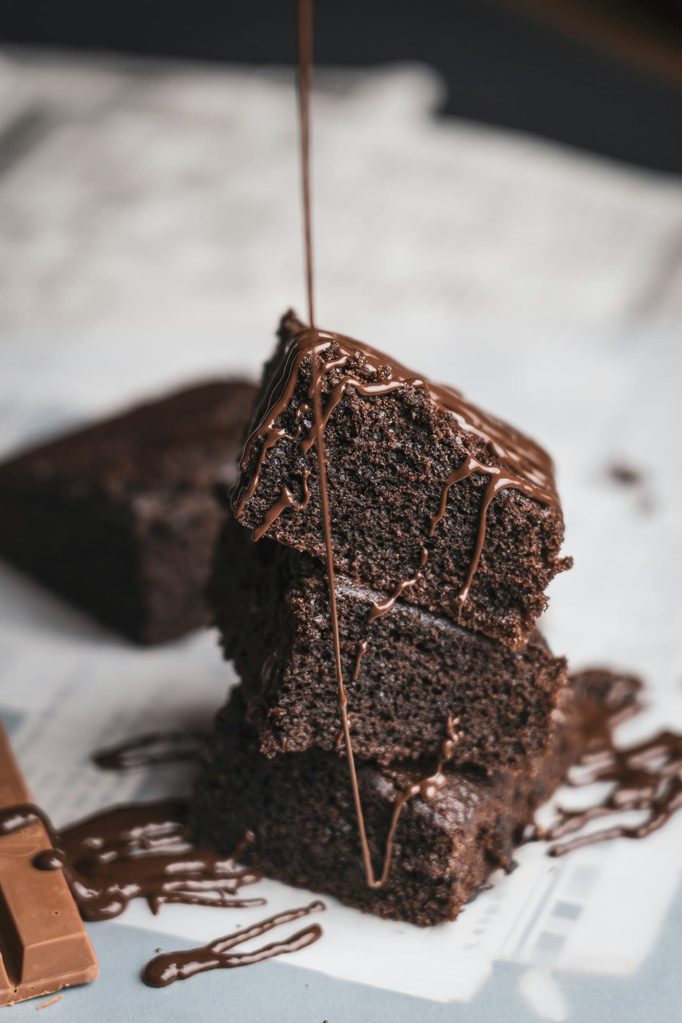 A dark chocolate dessert with chocolate sauce and cocoa crust