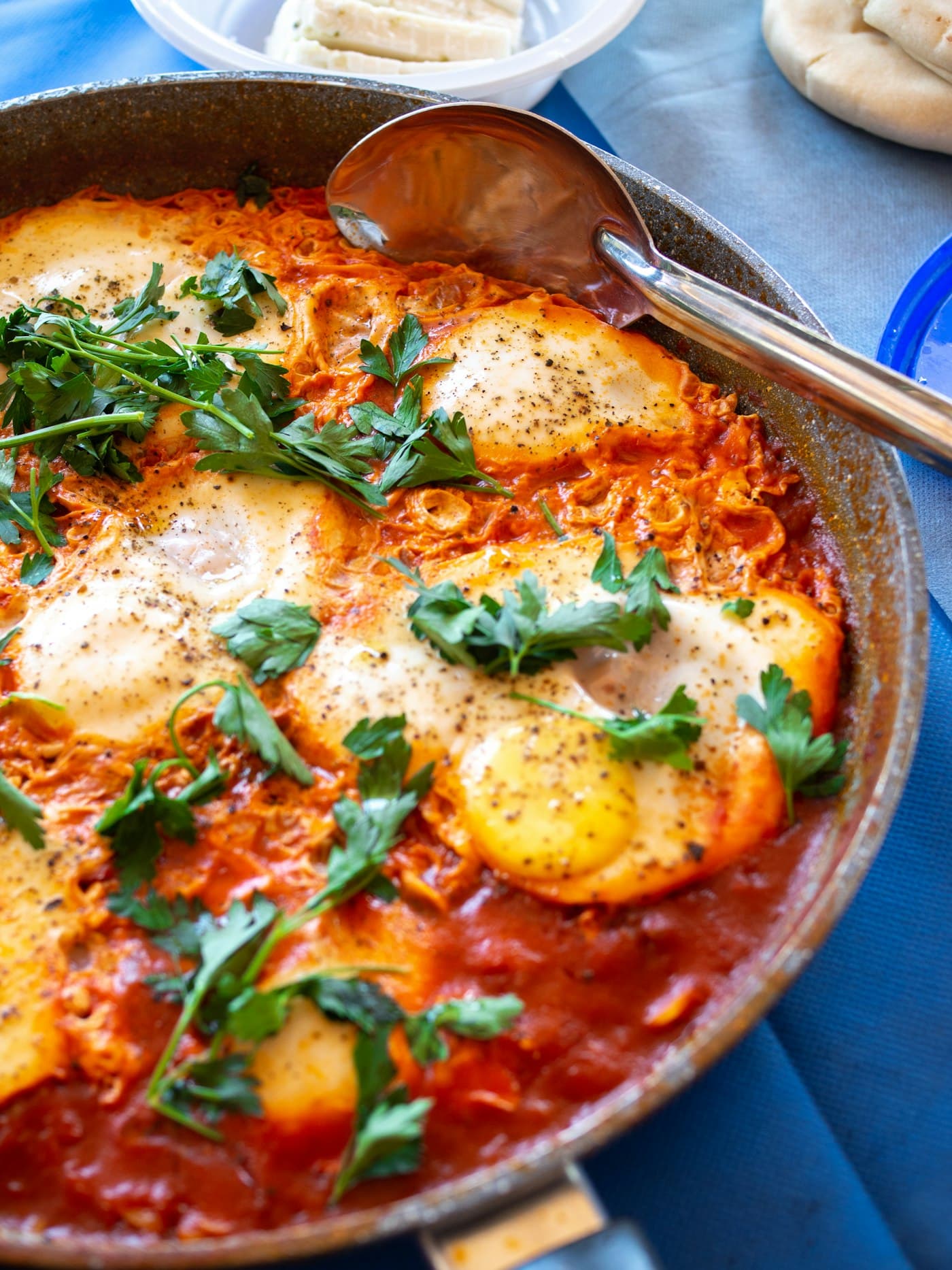 Shakshuka — eggs baked in spiced tomato sauce with herbs, in a pan