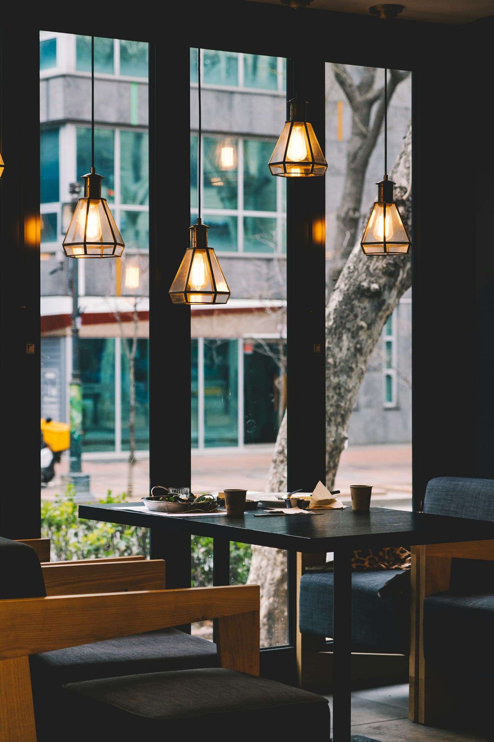 A window seat with warm table lamps looking onto the street