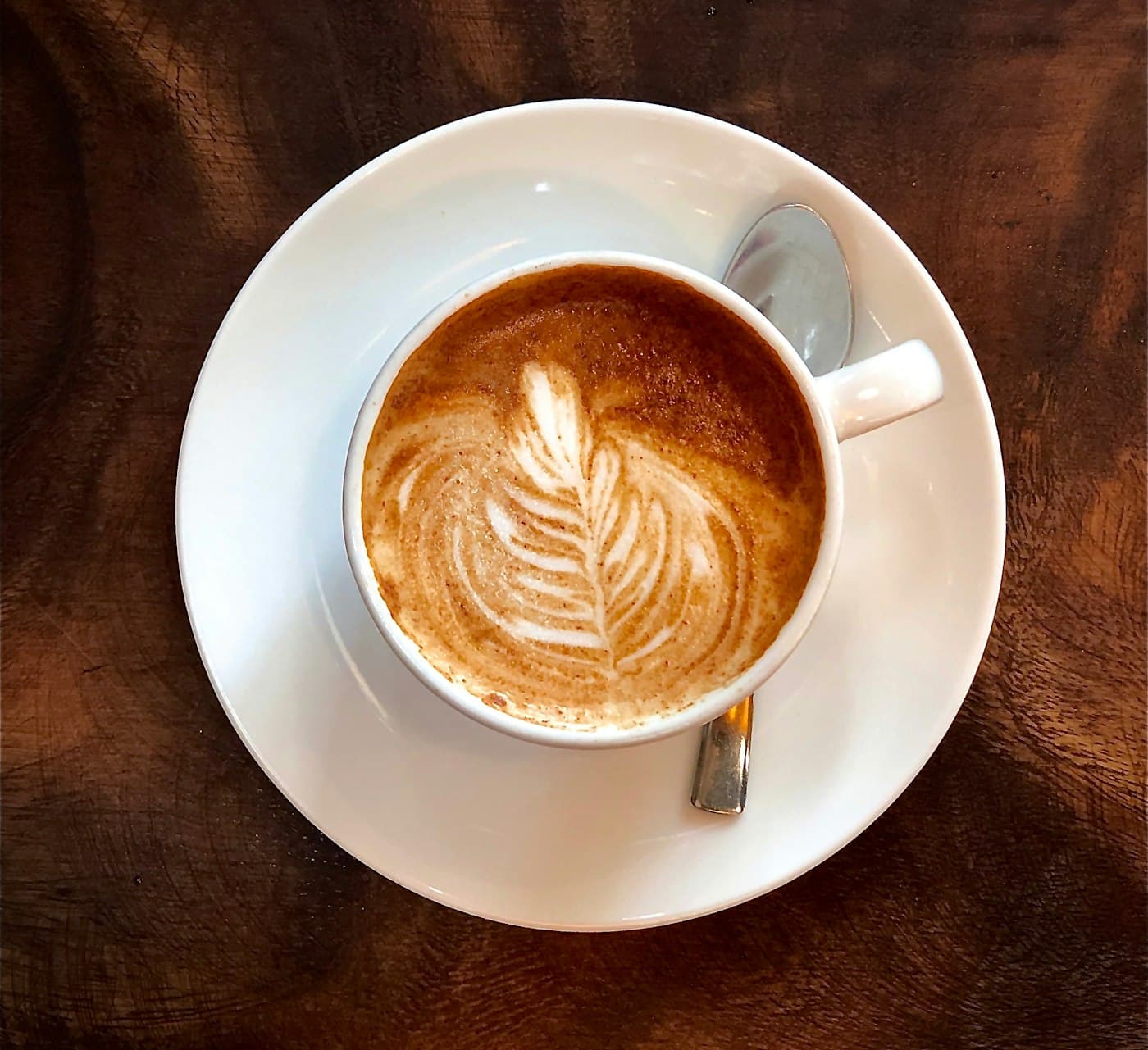 The Morrow Signature coffee seen from above, latte art on a walnut counter