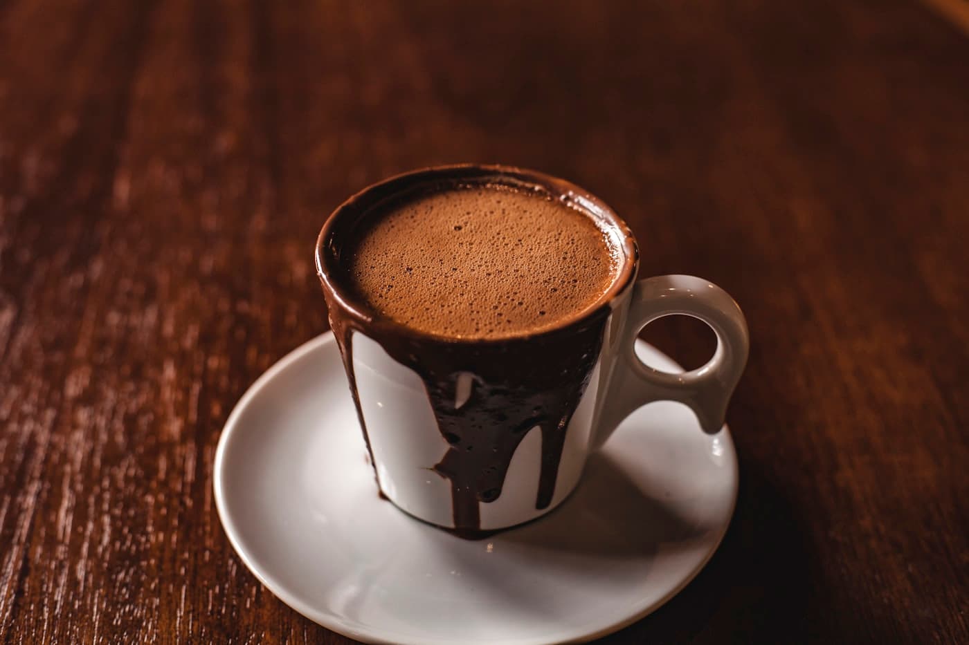A short black espresso in a dark ceramic cup on a walnut table at Morrow & Bean